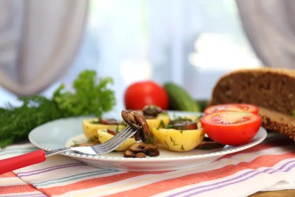 Junge Pellkartoffeln auf dem Tisch vor dem Fenster — Stockfoto