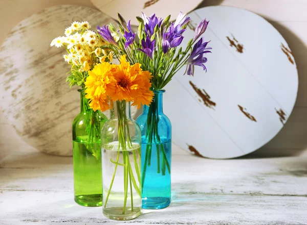 Beautiful wild flowers on wooden background — Stock Photo, Image