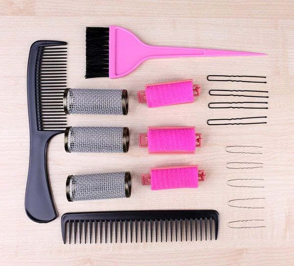 Professional hairdresser tools - comb, scissors and pins on light wooden background — Stock Photo, Image