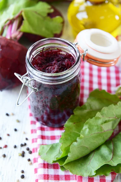 Grated beetroots in jar on table close-up — Stock Photo, Image