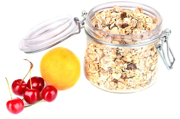 Homemade granola in glass jar and fresh berries, isolated on white — Stock Photo, Image