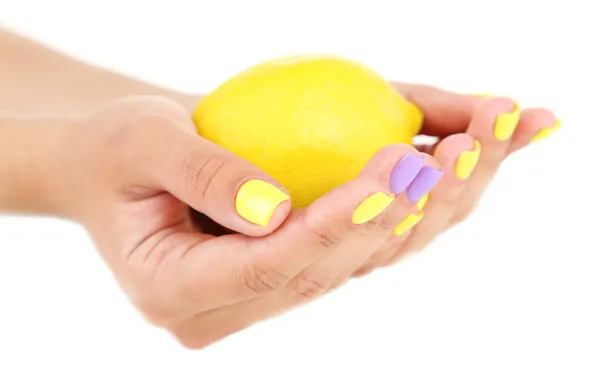 Female hands with stylish colorful nails holding fresh lemon, isolated on white — Stock Photo, Image