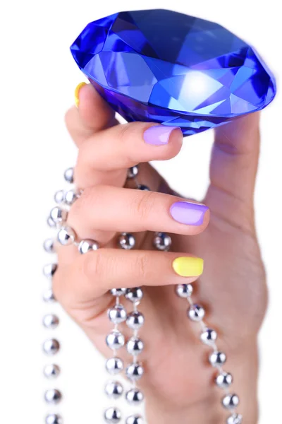 Mano femenina con uñas elegantes y coloridas sosteniendo piedra brillante decorativa, aislada en blanco —  Fotos de Stock