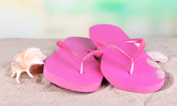 Bright flip-flops on sand, on nature background — Stock Photo, Image