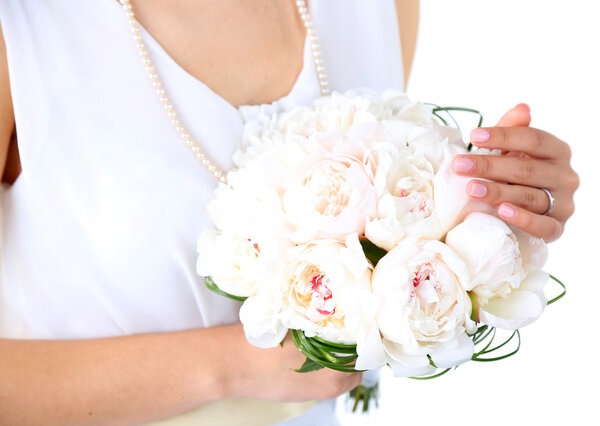 Bride holding wedding bouquet of white peonies, close-up, isolated on white