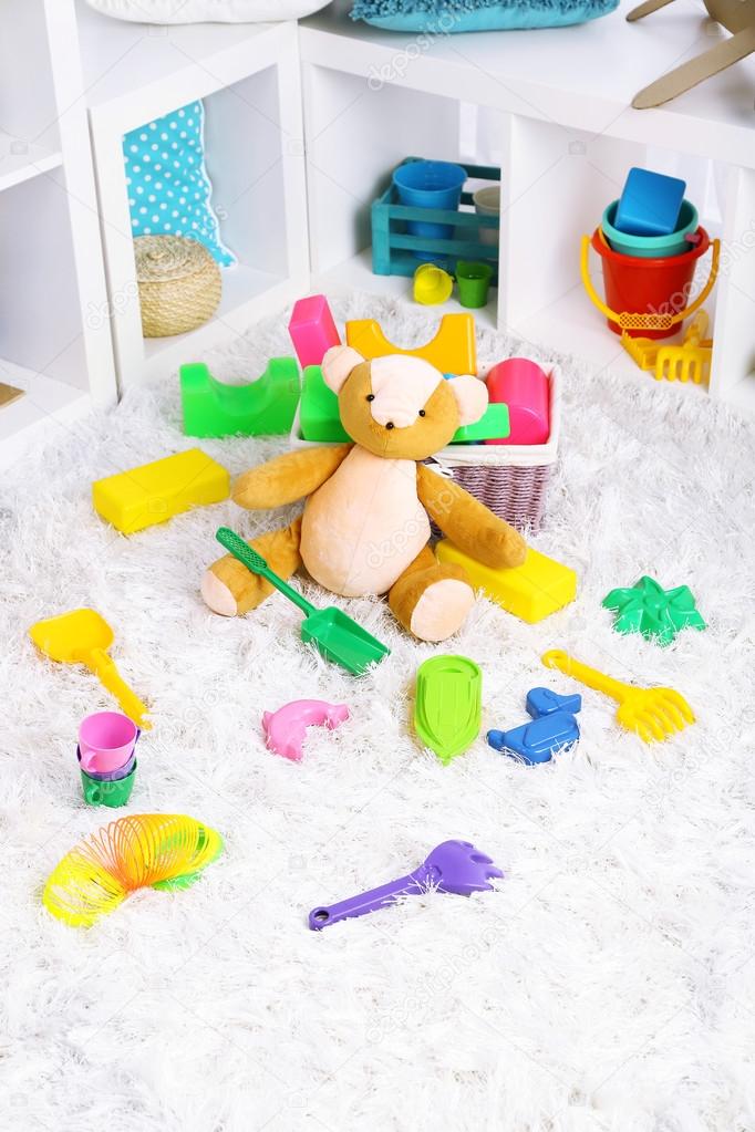 Colorful toys on fluffy carpet in children room