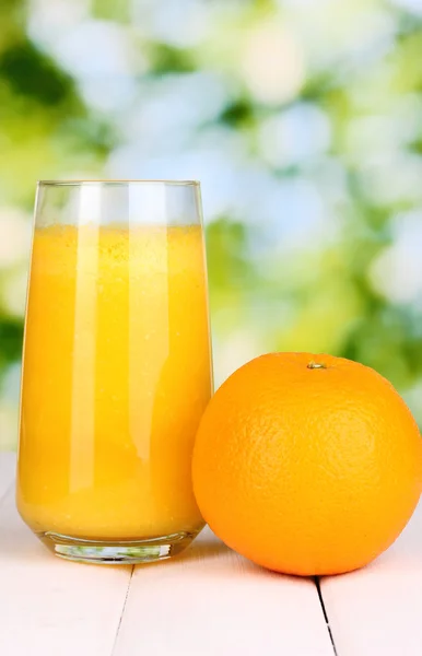 Glas färsk apelsinjuice på träbord — Stockfoto