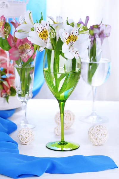Freesias in glasses on table — Stock Photo, Image