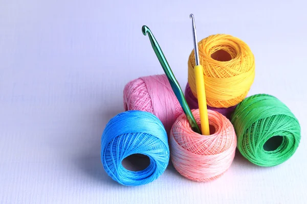 Colorful clews and crochet hooks — Stock Photo, Image