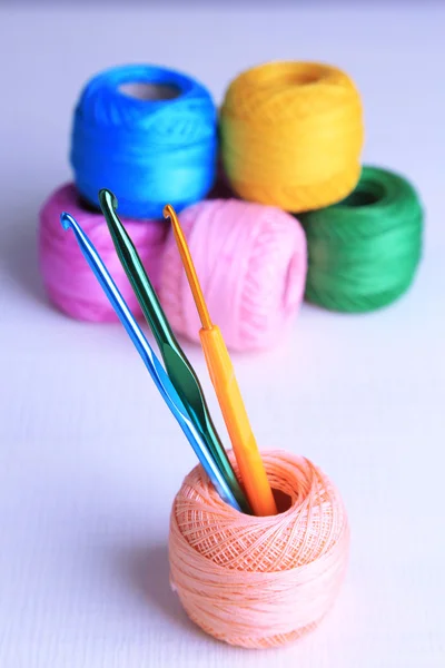 Colorful clews and crochet hooks — Stock Photo, Image