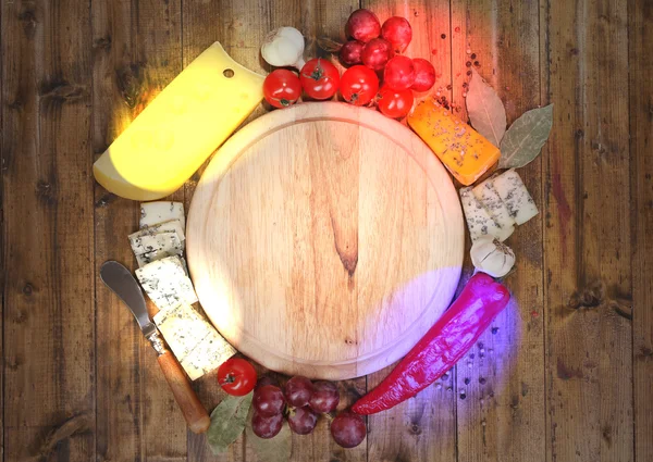 Different types of cheese with empty board — Stock Photo, Image