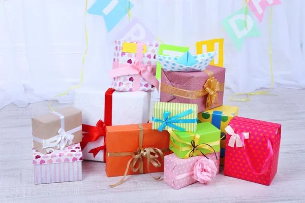 Many birthday gifts in room — Stock Photo, Image