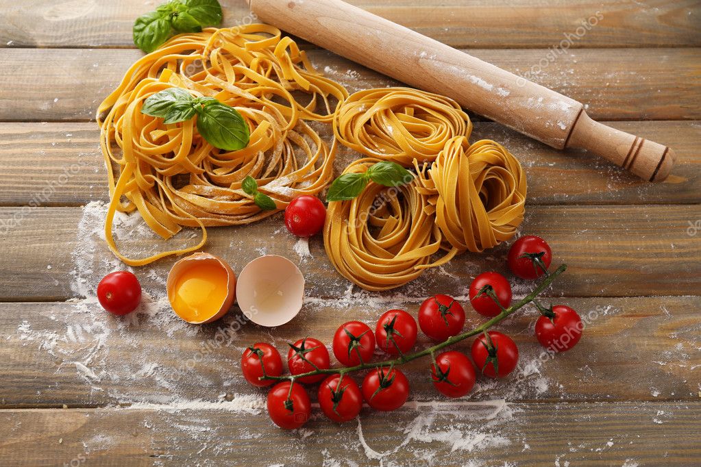 Raw pasta and ingredients for pasta — Stock Photo © belchonock #48602647
