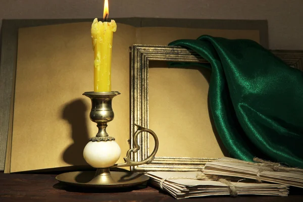 Old candle on table in room — Stock Photo, Image