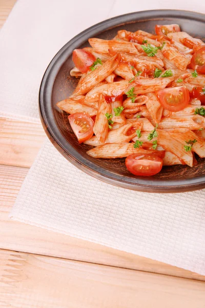 Pasta with tomato sauce on plate on table — Stock Photo, Image