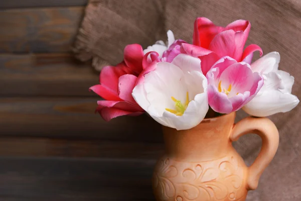 Beautiful tulips in bucket in pitcher — Stock Photo, Image