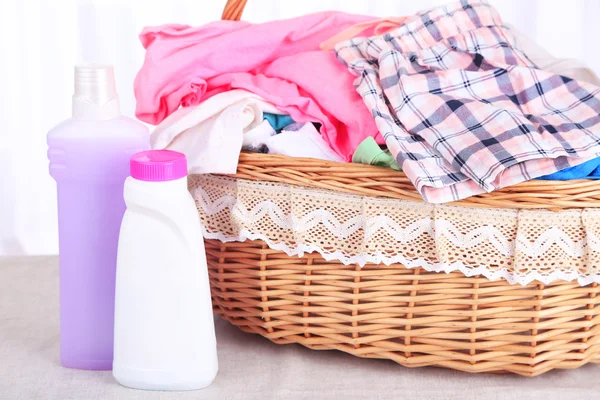 Colorful clothes in basket on table — Stock Photo, Image