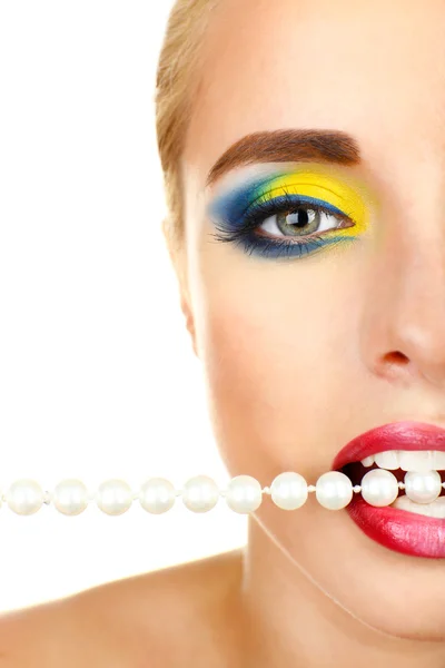 Beautiful woman with bright make-up and necklace in mouth — Stock Photo, Image