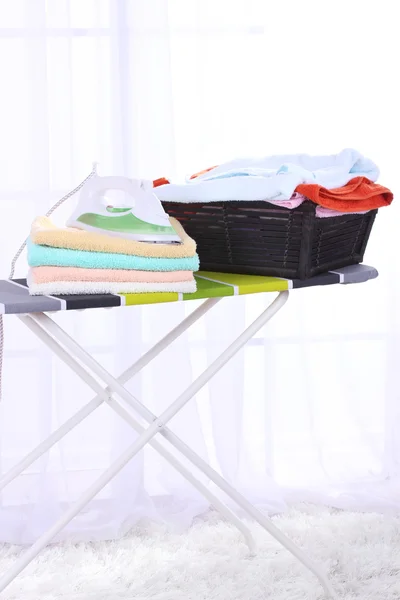 Basket with laundry and ironing board — Stock Photo, Image