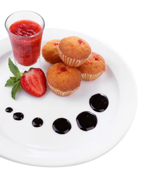 Tasty muffins with chocolate and red currant sauces on plate isolated on white — Stock Photo, Image
