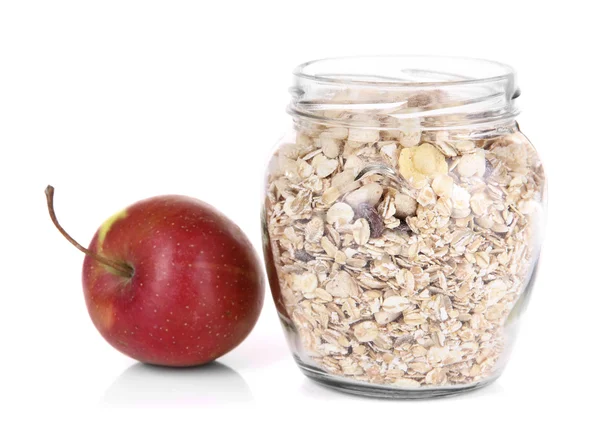 Hemgjord granola i glasburk och äpple, isolerad på vit — Stockfoto