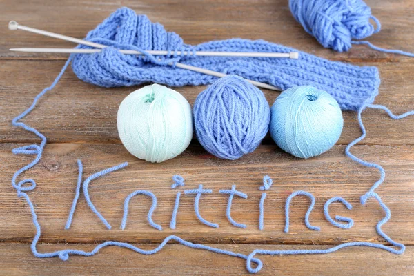 Yarns for knitting on wooden table — Stock Photo, Image