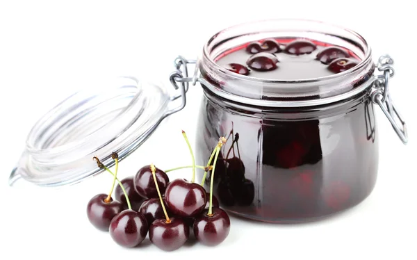 Tasty cherry jam in glass jar on wooden table — Stock Photo, Image