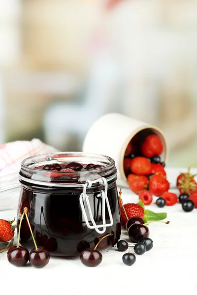 在木制的桌子上的玻璃罐子里的浆果的美味果酱 — 图库照片
