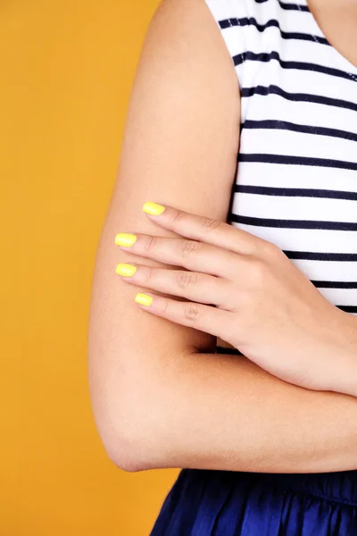 Female hand with stylish colorful nails, close-up, on color background — Stock Photo, Image