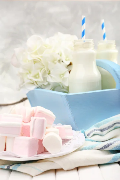 Milk in bottles with paper straws on table — Stock Photo, Image