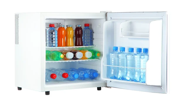 Mini fridge full of bottles of juice, soda and fruit — Stock Photo, Image