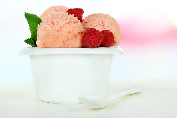 Tasty ice cream scoops in bowl, on wooden table — Stock Photo, Image