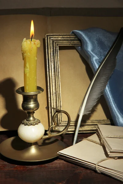Old candle on table in room — Stock Photo, Image