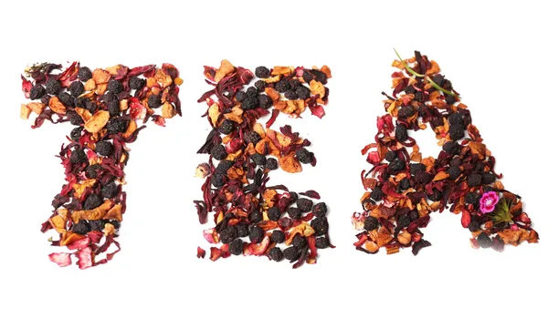 Mistura de chá com frutas e especiarias em forma de palavra — Fotografia de Stock