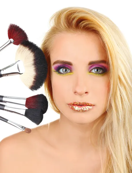 Woman with bright make-up and brushes — Stock Photo, Image