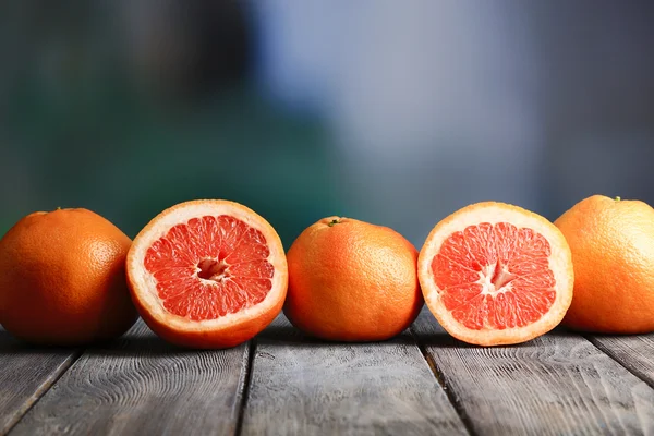 Ripe grapefruits on wooden board — Stock Photo, Image