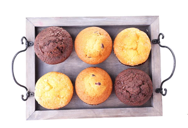 Tasty muffins on wooden tray isolated on white — Stock Photo, Image