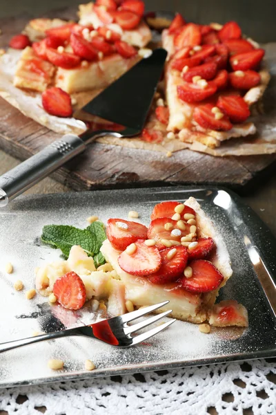 Piece of strawberry tart on  tray, on rustic wooden background — Stock Photo, Image