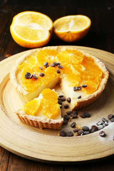 Homemade orange tart with coffee grains on wooden background — Stock Photo, Image