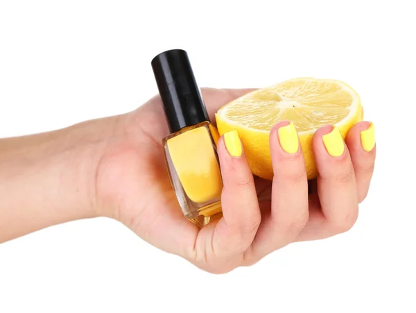 Mão feminina com unhas coloridas elegantes segurando limão fresco e garrafa com esmalte — Fotografia de Stock