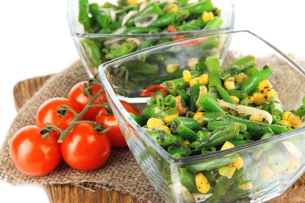 Salad with green beans, ham and  corn in glass bowls, on wooden board, isolated on white — Stock Photo, Image