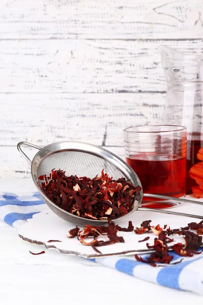 Hibiscus dried tea and flower on wooden background — Stock Photo, Image