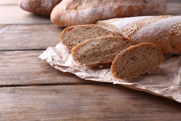 Fresh bread on wooden background — Stock Photo, Image