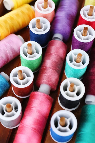 Colorful threads for needlework in wooden box close up — Stock Photo, Image