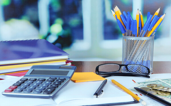 Office supplies with documents and money on table