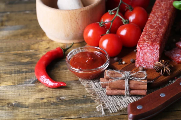 Tasty salami sausage and spices — Stock Photo, Image