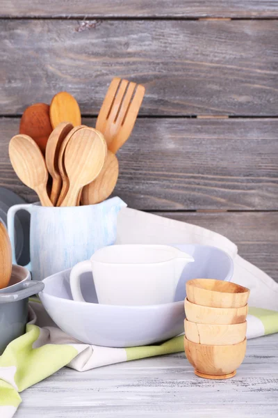 Wooden cutlery, pan, bowl and cutting board — Stock Photo, Image