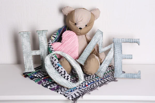 Decorative letters forming word HOME with teddy bear — Stock Photo, Image