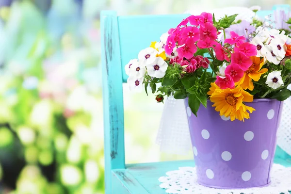 Flowers in decorative bucket — Stock Photo, Image