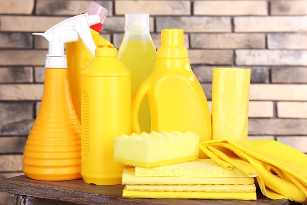 Cleaning products on shelf on bricks wall background — Stock Photo, Image